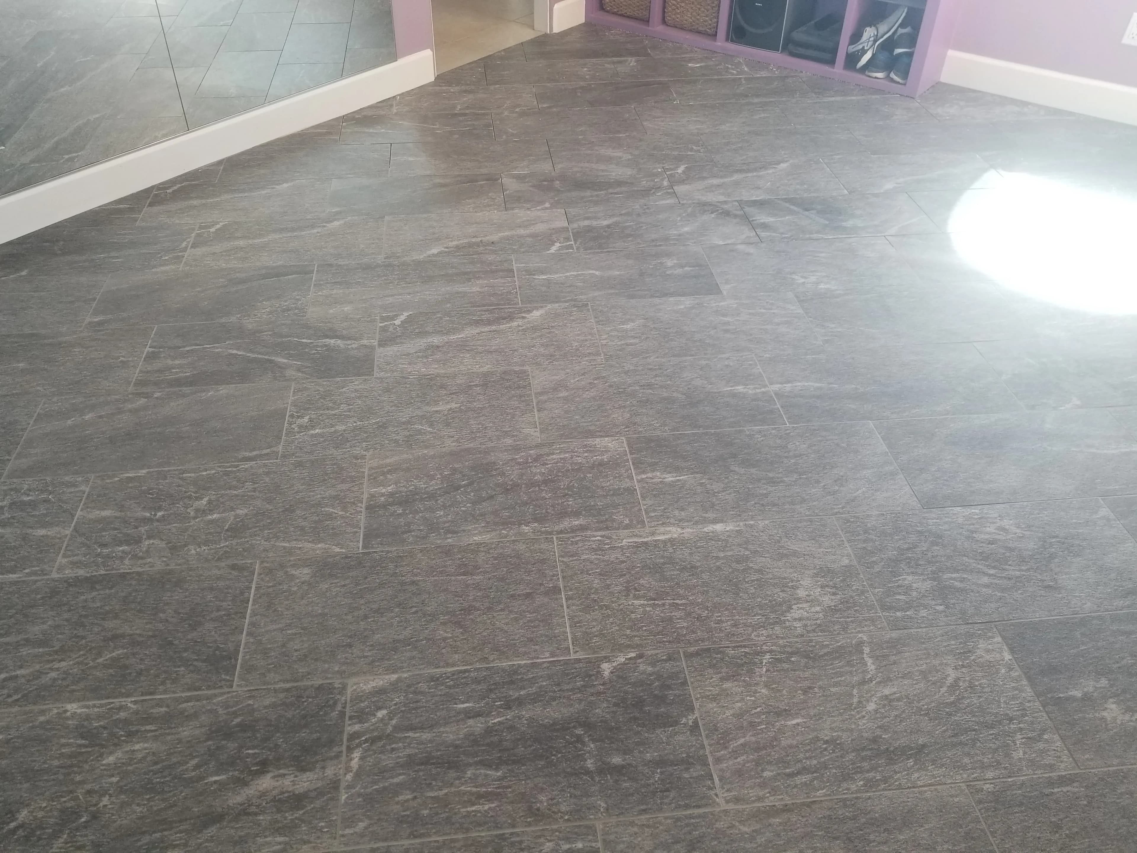 Gray stone-look tile floor with large rectangular tiles and subtle texture